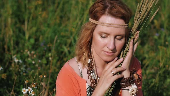Portrait of a Blonde Hippie Girl with Ears of Wheat in Her Hands