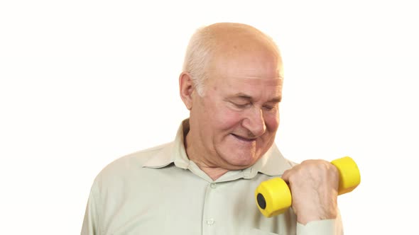 Happy Old Man Showing Thumbs Up Working Out with a Dumbbell
