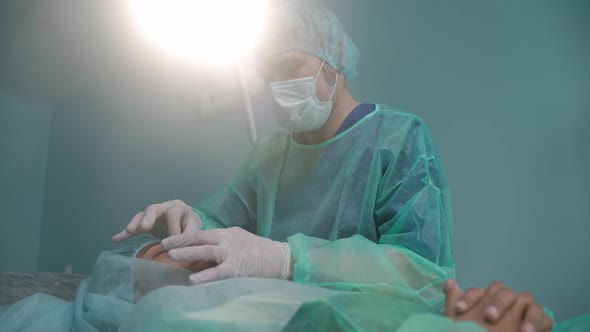 Closeup Shot of Surgeon Performing Rhinoplasty in Green Protective Gowns