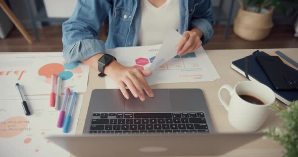 Asia businesswoman using tablet talk to colleagues about plan in video call while working from house