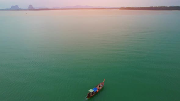 An aerial view of a boat cruising forward into the estuary alt