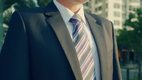 The Shot Moves Around a Businessman in Luxury Clothing Standing on a Street in the City Centeron a alt