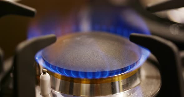 Gas burner on the stove in the kitchen alt