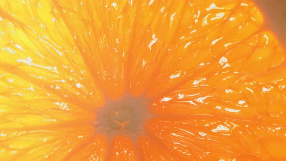 Drop of Water Flows Down the Surface of a Ripe Juicy Orange Slice alt