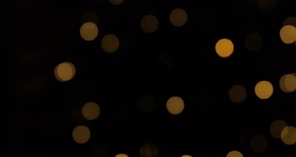 Moving from left golden lights hang and glow in the evening, vintage garland of lamps alt