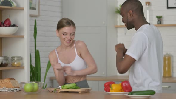 Sporty African Man and Woman Dancing in Kitchen alt