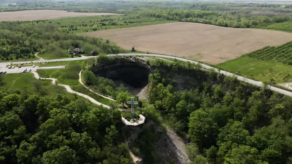 Aerial drone flight over famous Devil's Punch Bowl surrounded by countryside at sunlight. Ontario,Ca alt
