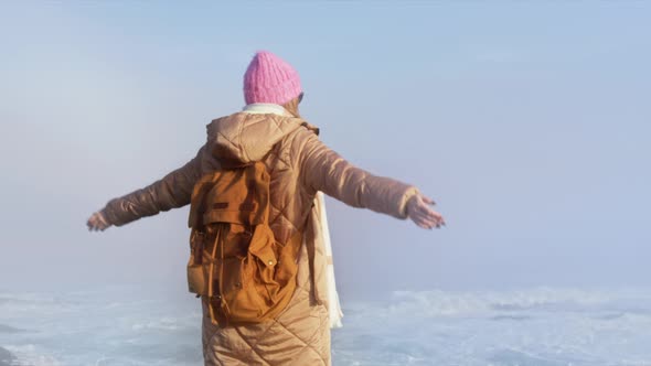 Slow Motion Happy Traveler Enjoying Coastal Nature in Cinematic Golden Sunrise alt