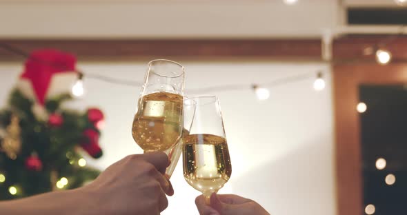 People clinking Champagne glasses celebrating Christmas