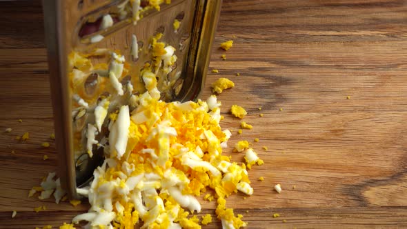 The Cook Rubs Egg on a Grater alt