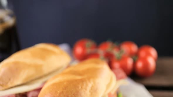 Sub sandwich with fresh vegetables, lunch meat and cheese on hoagie roll. alt