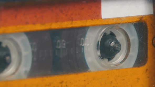 The Vintage Yellow Audio Cassette in the Tape Recorder Rotates alt