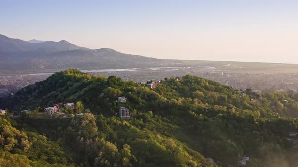 Sunset landscape of blooming hills and valleys against river delta and Black sea expanse alt