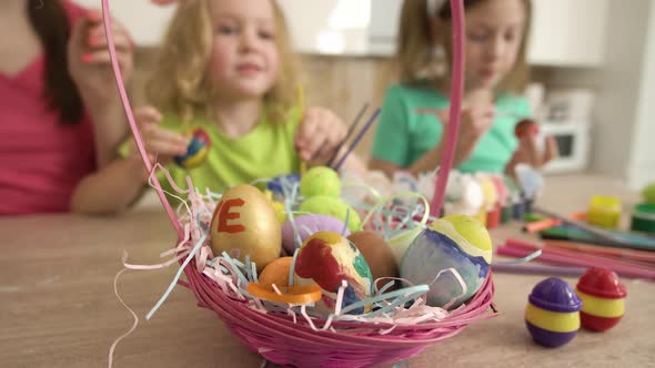 Closeup of a Basket with Easter Eggs on a Wooden Table