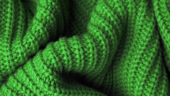 The Texture of the Fabric. Green Knitted Texture. Close-up. Can Be Used As a Background. alt