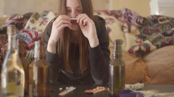 Portrait of a Drug Addicted Girl Who Consumes Alcohol and Drugs alt