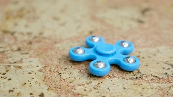Blue Hand Spinner To Spin on a Wooden Table