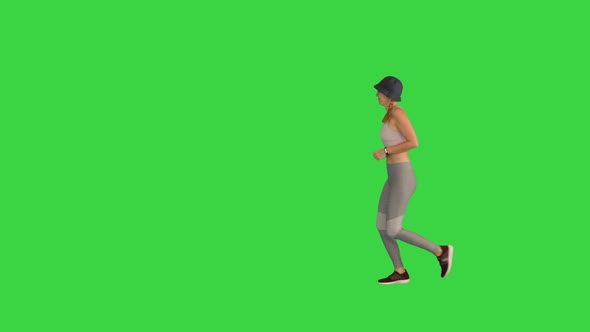 Female Runner Jogging in Sporty Outfit on a Green Screen Chroma Key