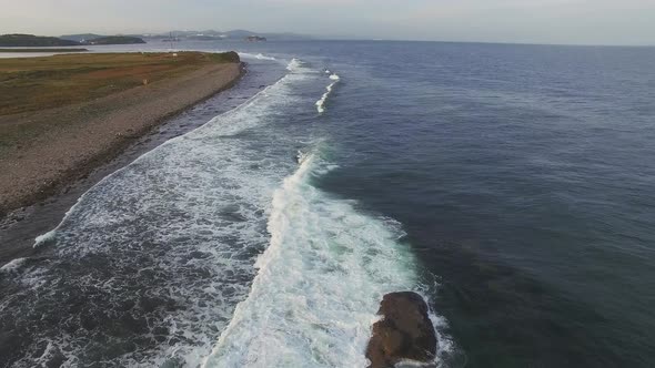 Drone View of the Sea Coast with Rocky Shore and Waves alt