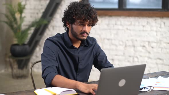 Modern Bearded Man Working with Laptop in Home Office