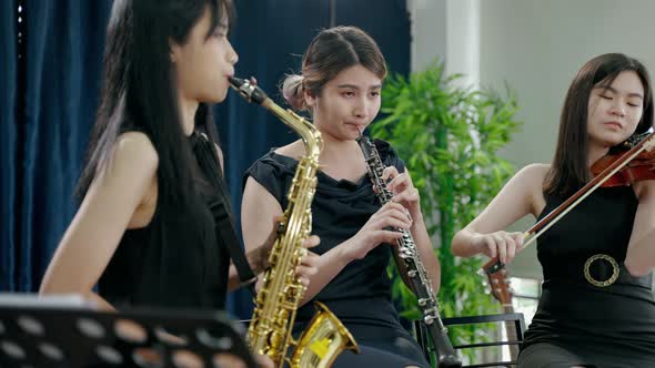 Classical band with girls Asian musicians are showing off their work online through social media.