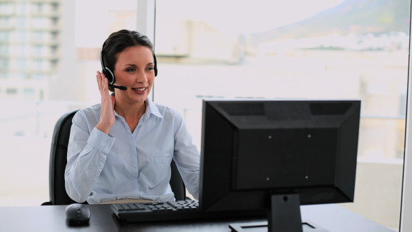 Call Center Agent On A Call At Her Desk alt