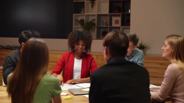 AfricanAmerican Businesswoman and Caucasian Businessman Shaking Hands After Signing Contract Members alt