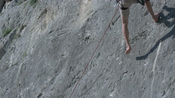 Barefoot rock climber descending Piatra Secuiului alt