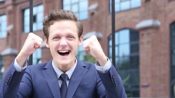 Successful Excited Businessman Celebrating Success, Standing Outdoor alt
