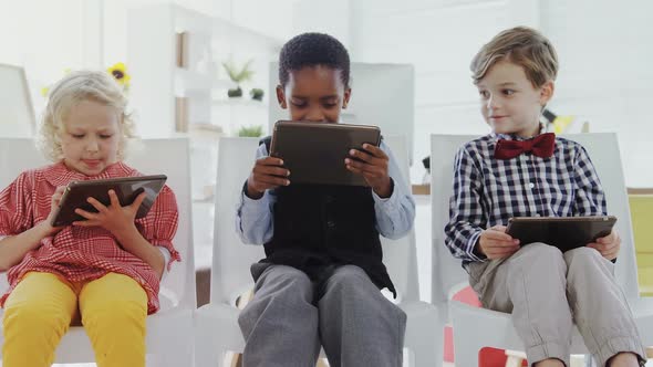 Kids as business executives using digital tablet 4k alt