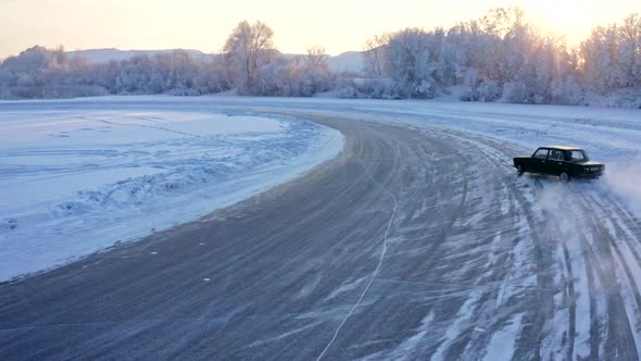 FPV Drone Shot of a Racing Car Sliding on an Ice Track on a Lake in Winter alt