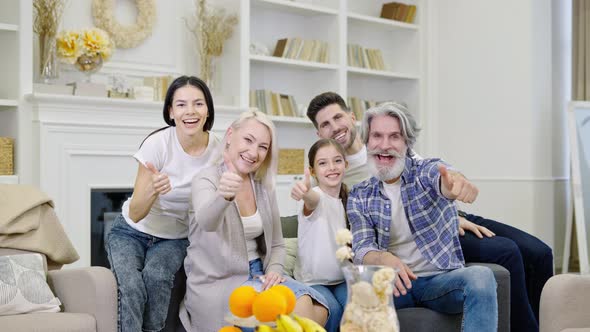 Big Happy Family Talking By Video Call or Taking Selfie While Sitting on Sofa at Home alt