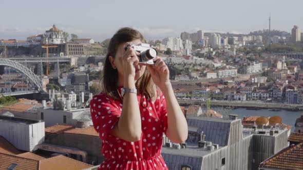 Woman Blogger Is Taking a Photo of Urban Panorama alt