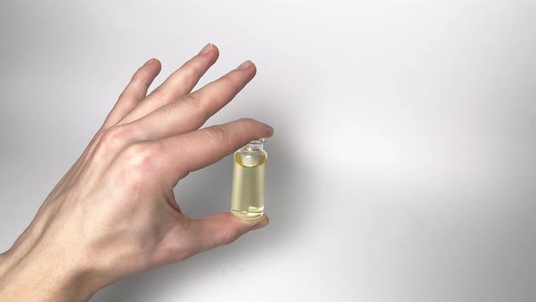 Holding bottles on white background. CBD pipette.  Bottle of Cannabis oil. Oil