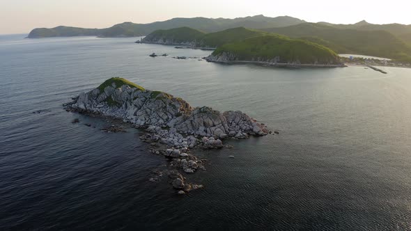 Rocky Islands in Triozerye Bay at Sunset alt