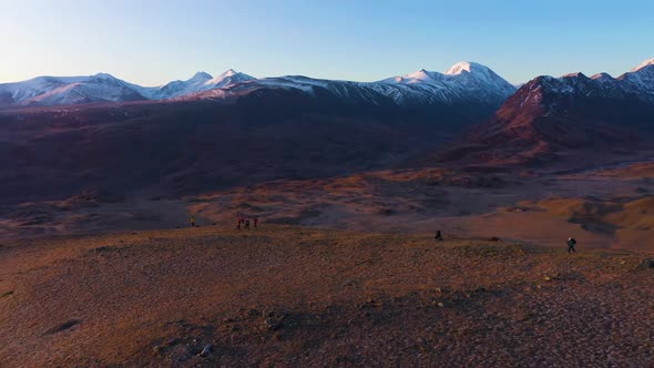 Photographers and Beltirdu Mountain Ridge. Aerial View. The Altai Mountains alt