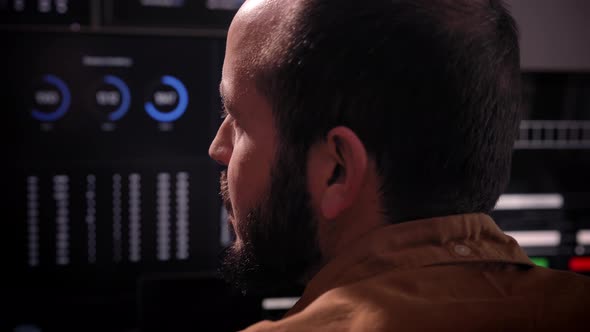 Over the Shoulder View of and Stock Broker Trading Online Monitoring Multiple Computer Screens Full alt