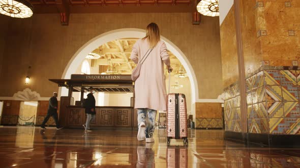 Traveler Woman in Casual Clothes Walking in Railroad Station or Bus Terminal 6K alt