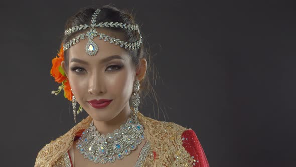 Stunning Indian bride in traditional dress smiles and poses for her fashion wedding portrait alt