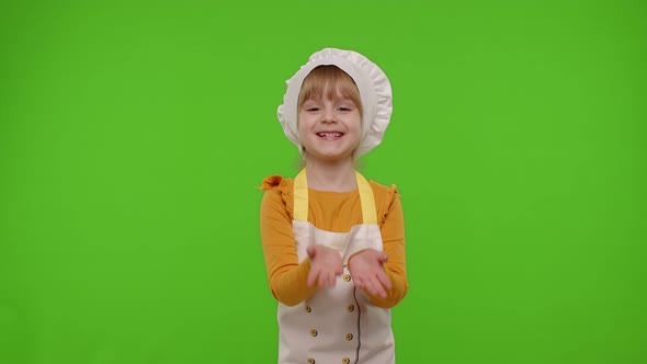 Child Girl Kid Dressed As Cook Chef Raising Hands Showing Tasty Gesture Smiling Looking at Camera alt