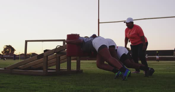 Young adult female rugby players training alt