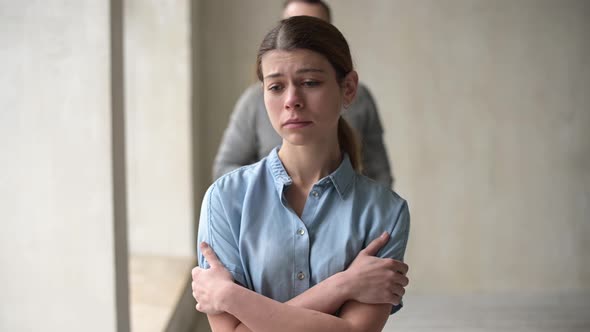 A young woman is sad and finds support in the arms of her beloved man alt