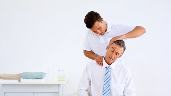 Physiotherapist Giving Businessman A Massage 1