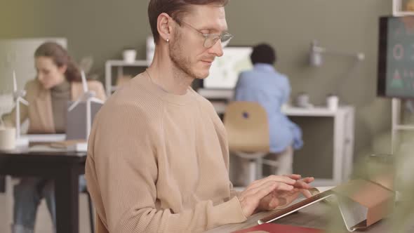 Engineer Working on Tablet PC in Office alt