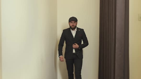 Stylish Young Man In Fitting Room Trying On New Suit. alt