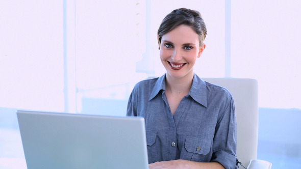 Happy Businesswoman Working On A Laptop 1
