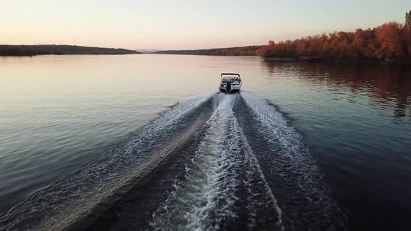  Motor Boat Floating on the River at Sunset