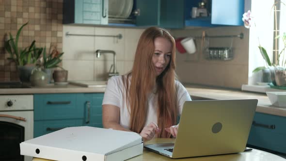 female open pizza box takes slice and enjoys eating food while resting from work alt