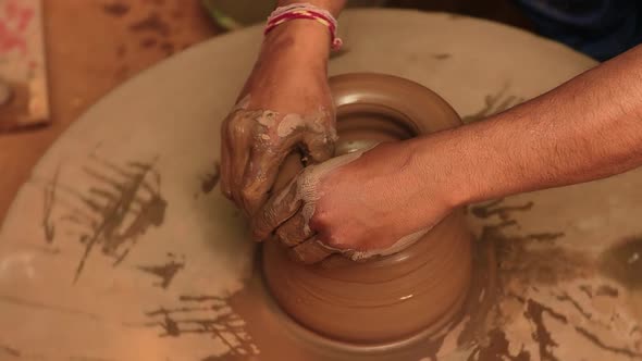 Potter at Work Makes Ceramic Dishes alt