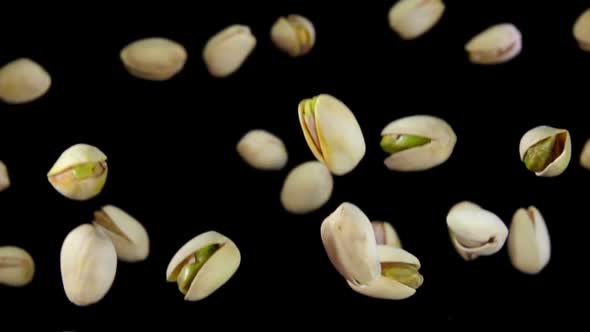 Fresh Pistachios Are Flying Up on a Black Background alt
